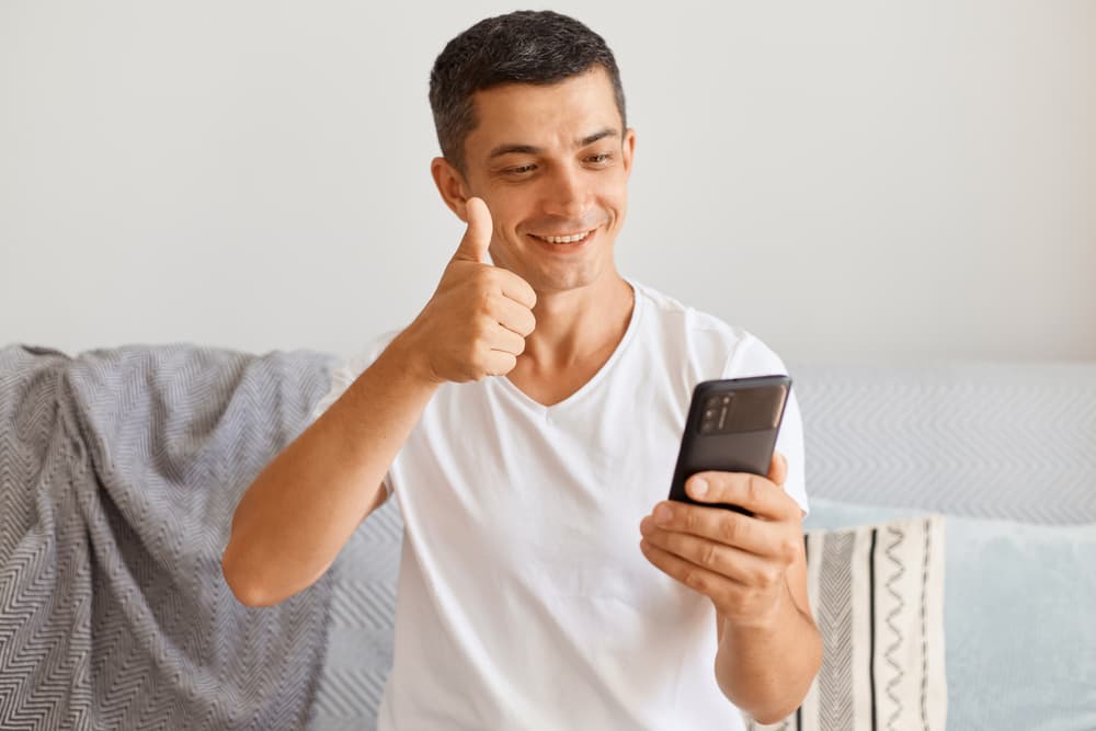 man thumbing up a video call