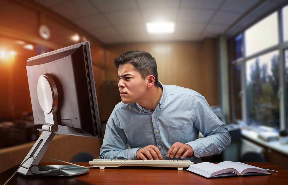 man suspicious of what he sees on computer